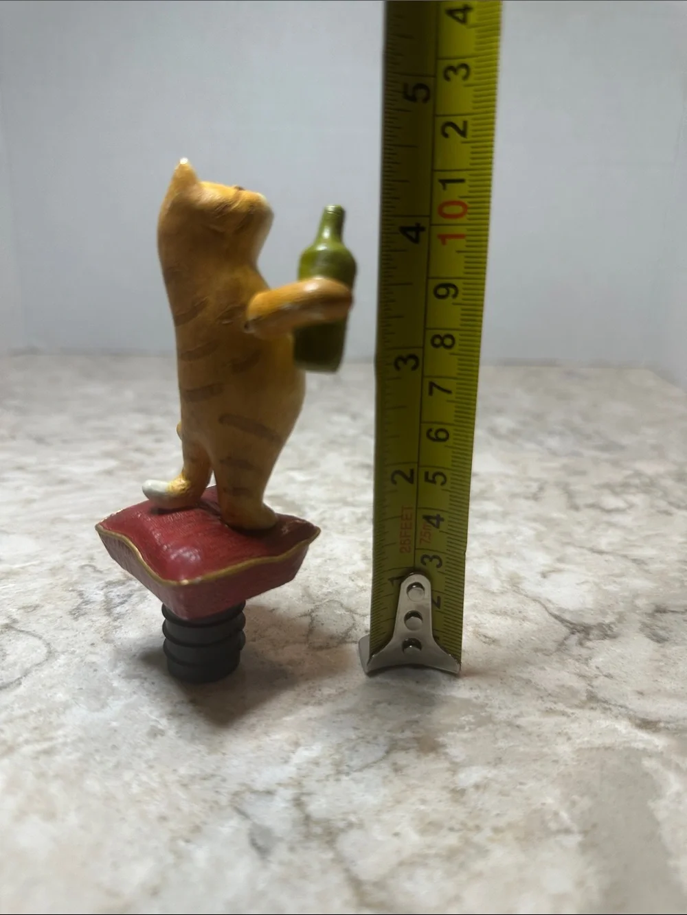 Yellow Cat Figurine Holding Bottle on Red Cushion- Bottle Stopper